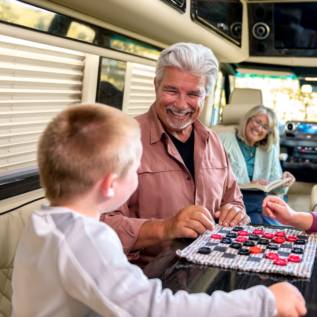 family playing checkers in the Ultimate RV cabin